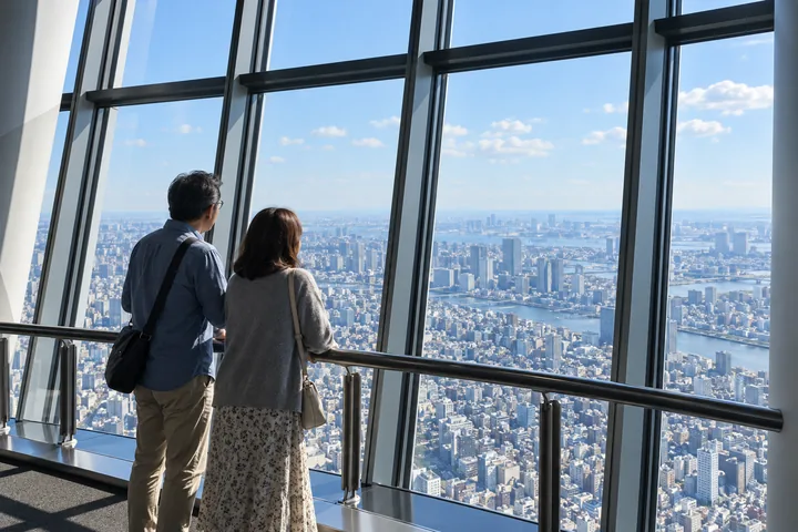 Una coppia che si prende il tempo di ammirare Tokyo dal Tembo Deck
